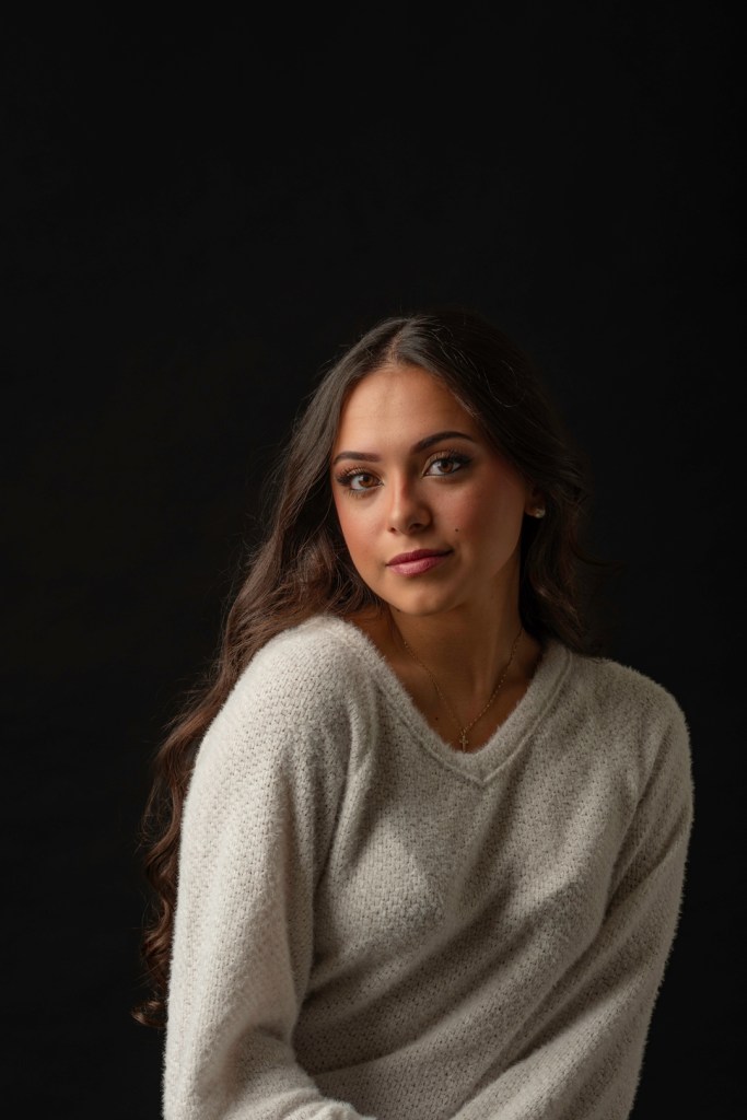 Woman in a white sweater. studio photography.