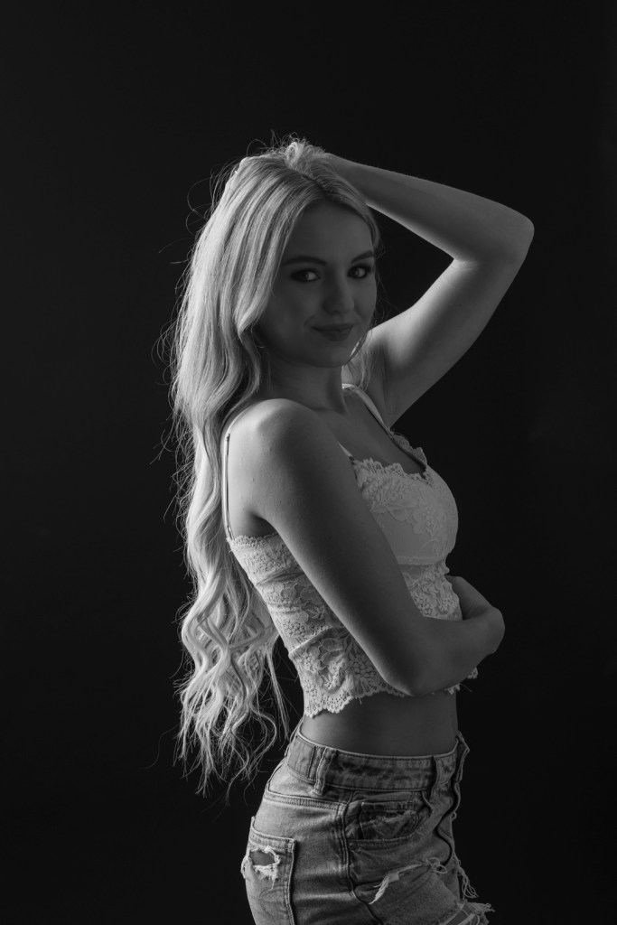 young woman runs her hand through her hair. studio photography.